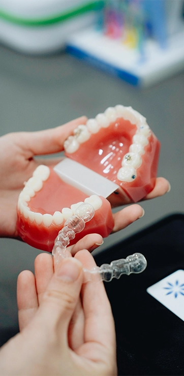 Hand Holding An Invisalign Aligner