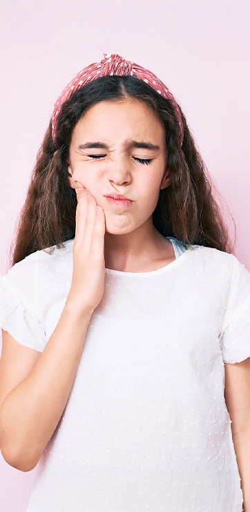 Young Girl With Tooth Pain In Front Of Pink Background